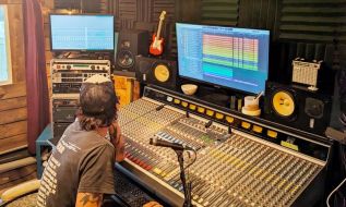 Producer/Singer/Guitarist Jonas Anthony-Lewis looks over Evergreen’s multi-track audio recorder.